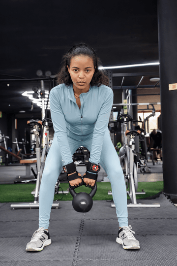 Woman lifting a kettlebell in a gym